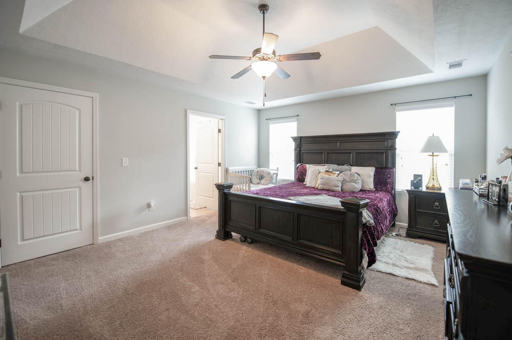 738 Neville Street Grovetown, GA 30813 - Photo 15 of 25 Owner’s suite with vaulted tray ceiling, fan, and large walk-in closet!