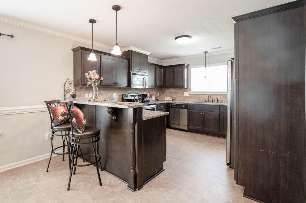 738 Neville Street Grovetown, GA 30813 - Photo 10 of 25 Great kitchen with granite countertops, breakfast bar, tumbled stone backsplash, and large window above sink for lots of natural light!