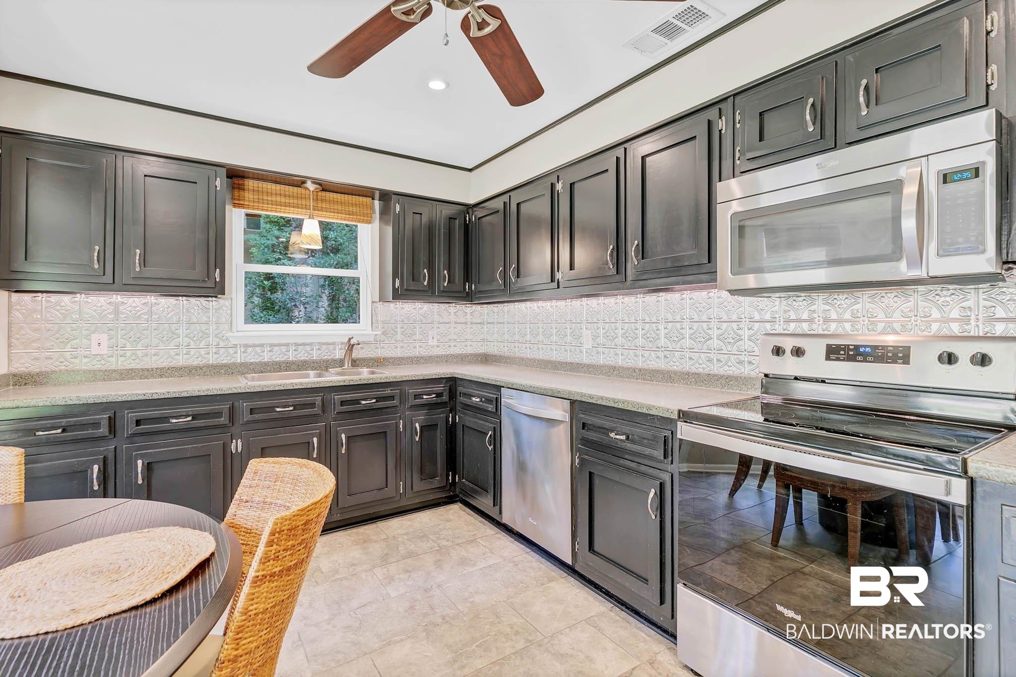 332 Ridgewood Drive Daphne, AL 36526 - Photo 18 of 48 Kitchen with stainless steel appliances, tasteful backsplash, light countertops, dark cabinetry, and recessed lighting