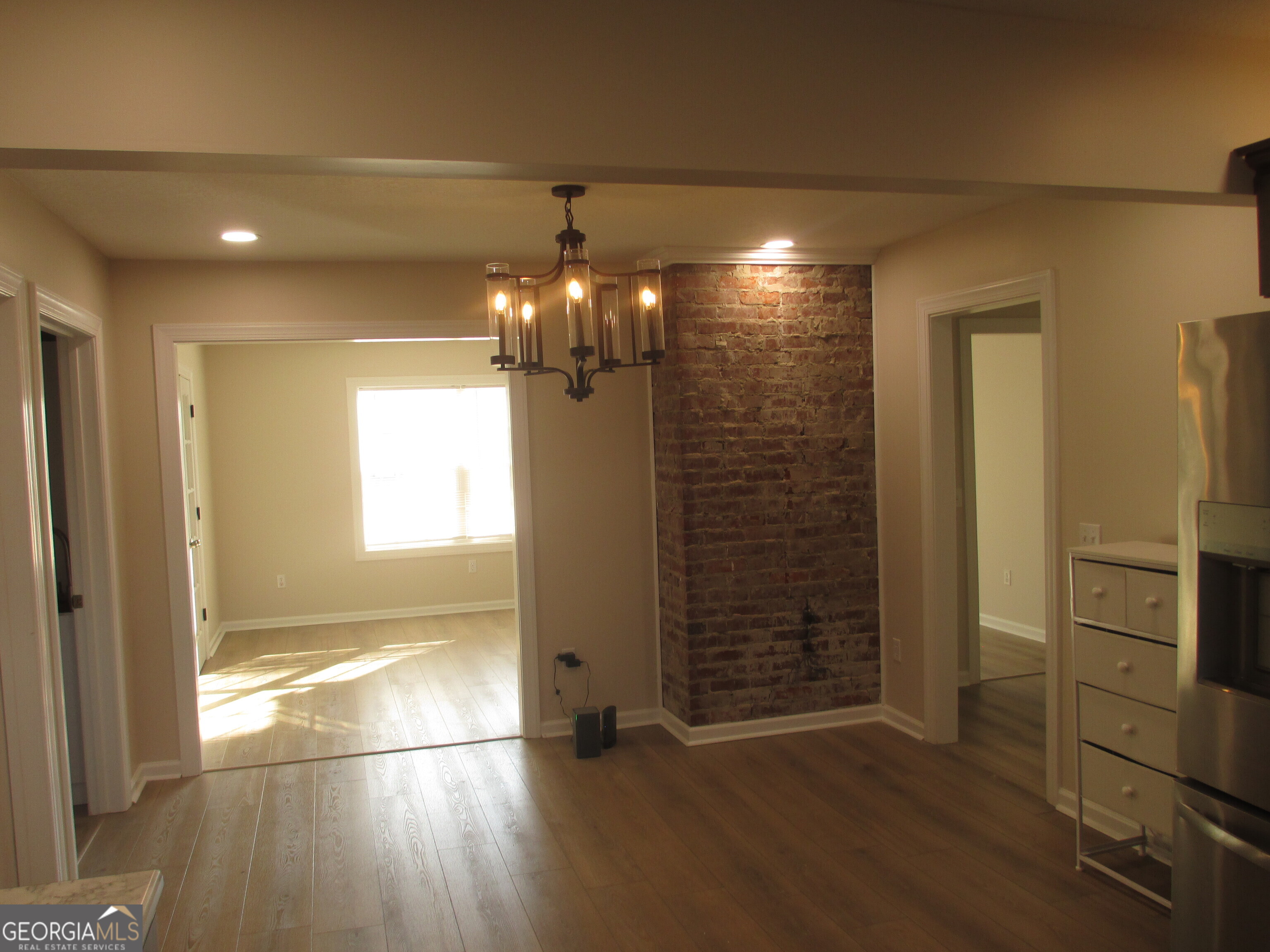 390 Bay Street Baxley, GA 31513 - Photo 14 of 24 wooden floor in an empty room with a window