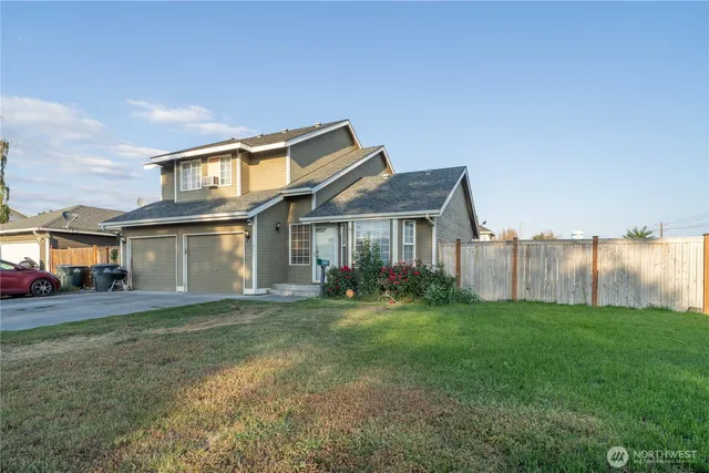 a view of a house with a yard and sitting area