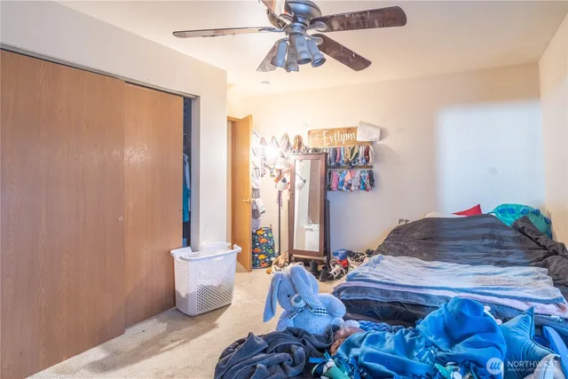 a bathroom with a sink toilet vanity and window