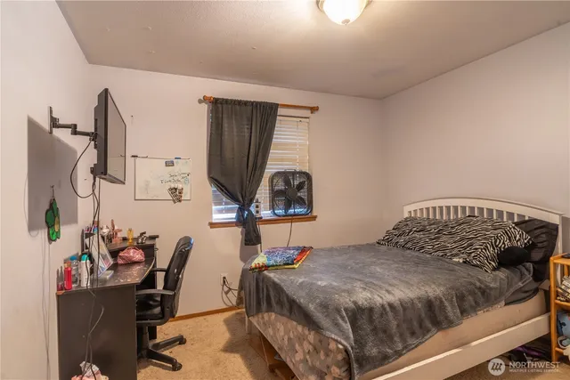 a view of workspace with wooden floor windows cabinet and chair