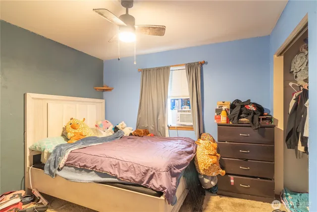 a bedroom with bed and a window