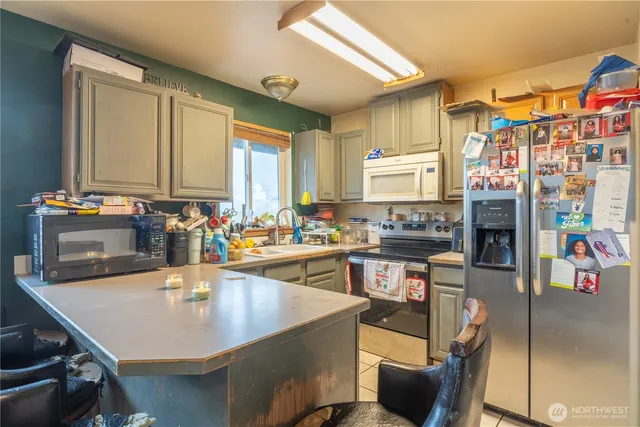 a kitchen with a dining table chairs and a counter top space
