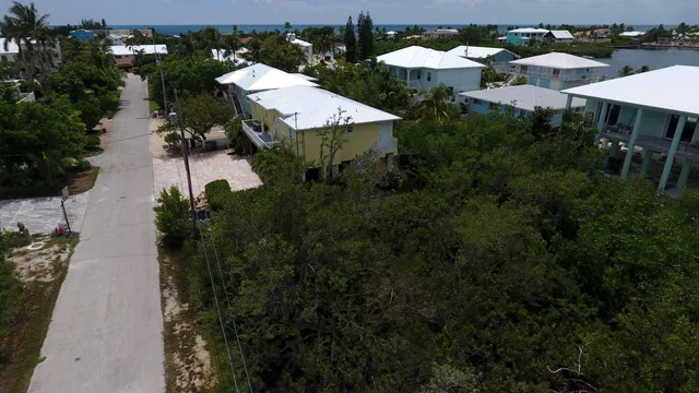 an aerial view of house with yard and outdoor seating