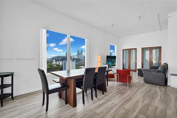 a dining room with furniture a fireplace and wooden floor