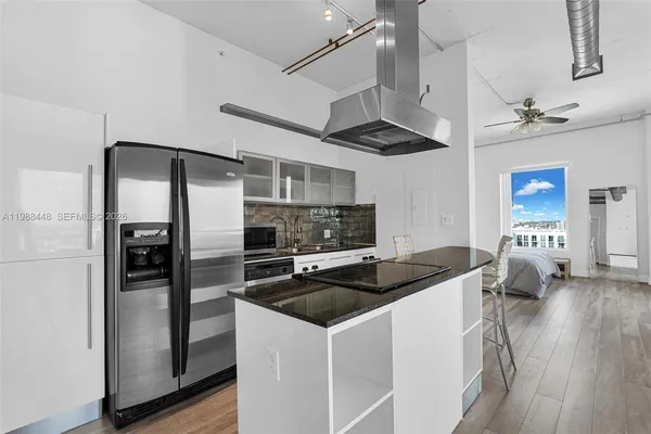 a kitchen that has a sink cabinets and stainless steel appliances