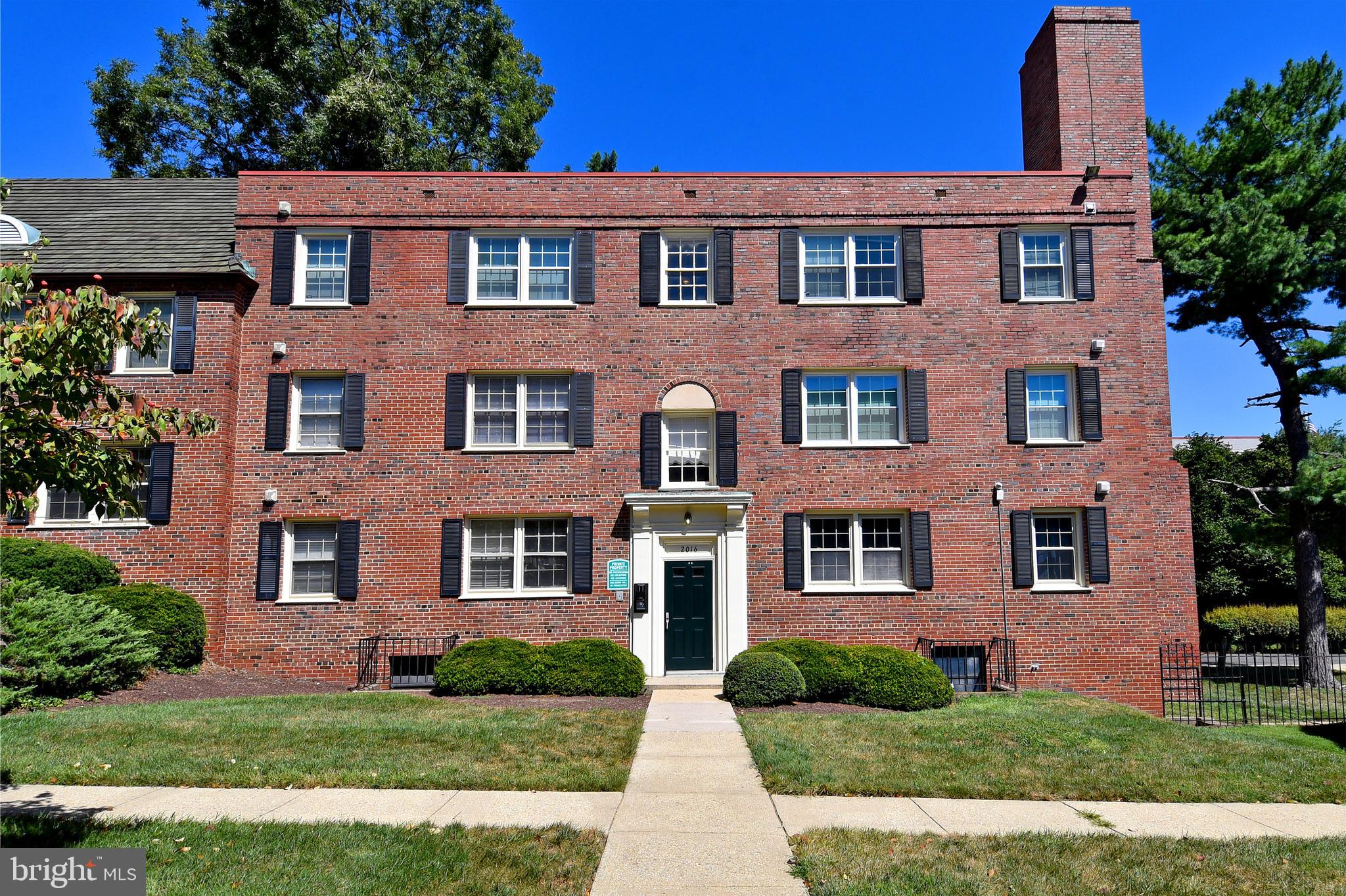 2016 37th Street Southeast, Unit 201 Washington, DC 20020 - Photo 1 of 17 a front view of a house with a yard