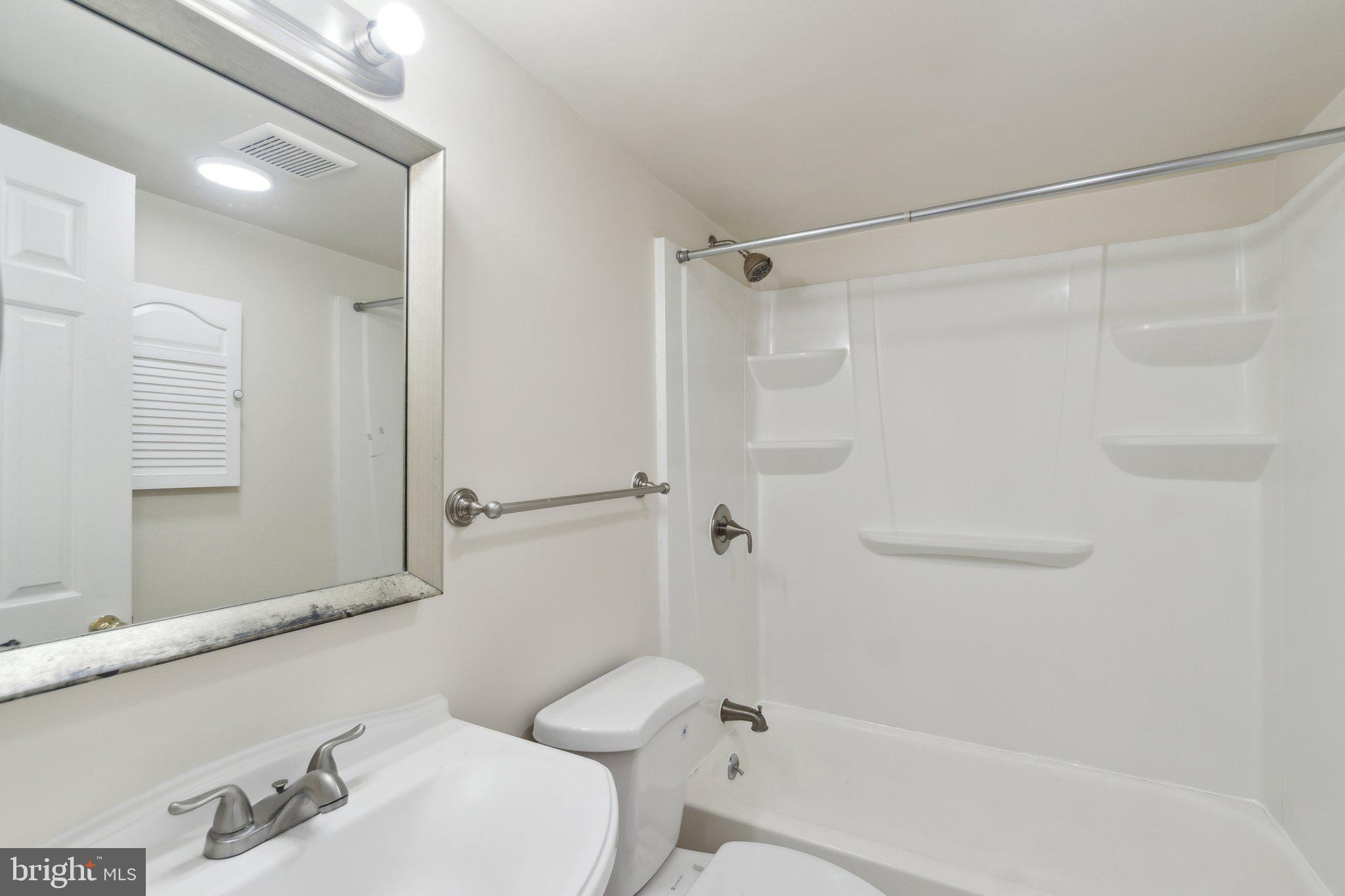 2016 37th Street Southeast, Unit 201 Washington, DC 20020 - Photo 12 of 17 a bathroom with a sink and a mirror
