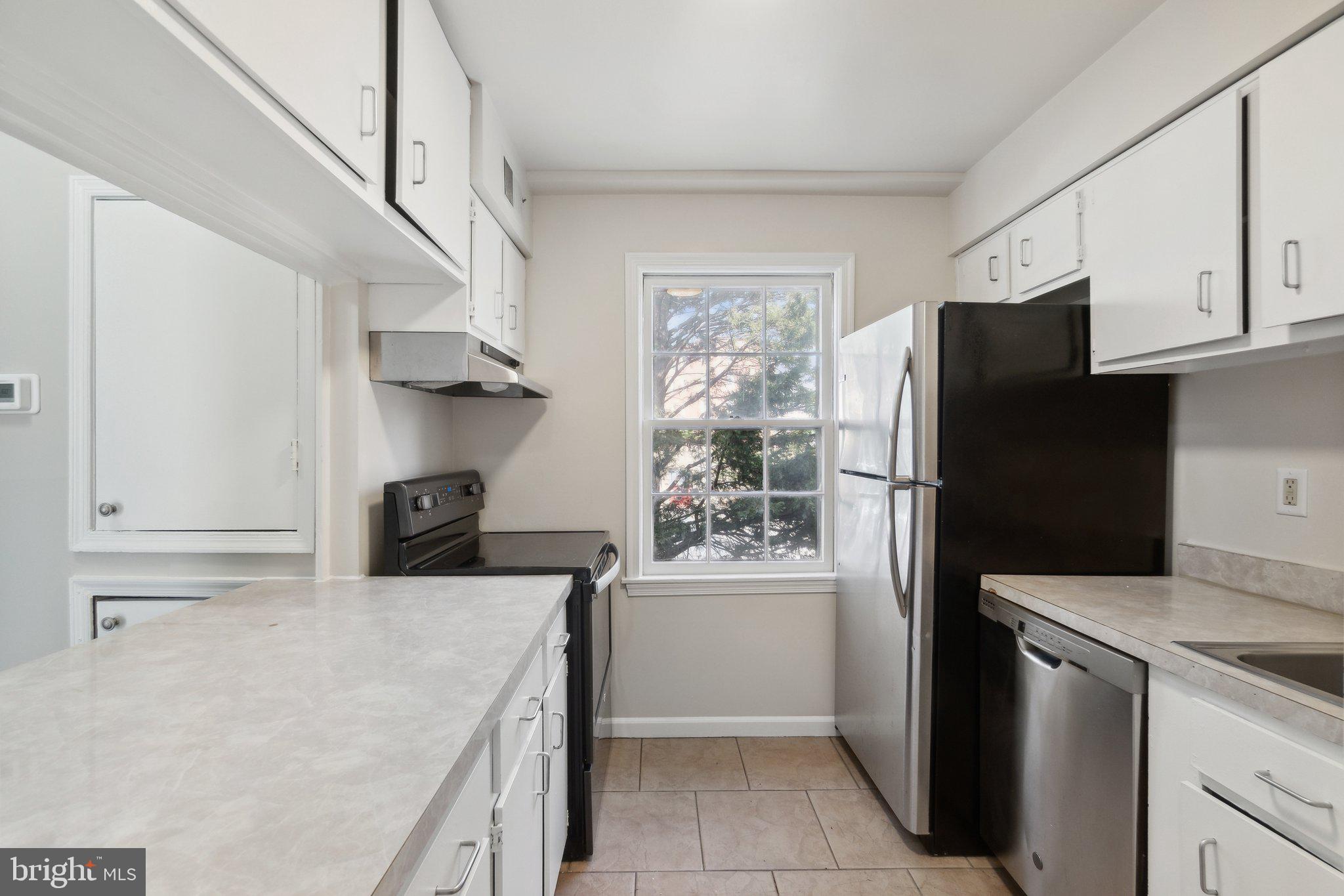 2016 37th Street Southeast, Unit 201 Washington, DC 20020 - Photo 3 of 17 a kitchen with a sink a refrigerator and a stove