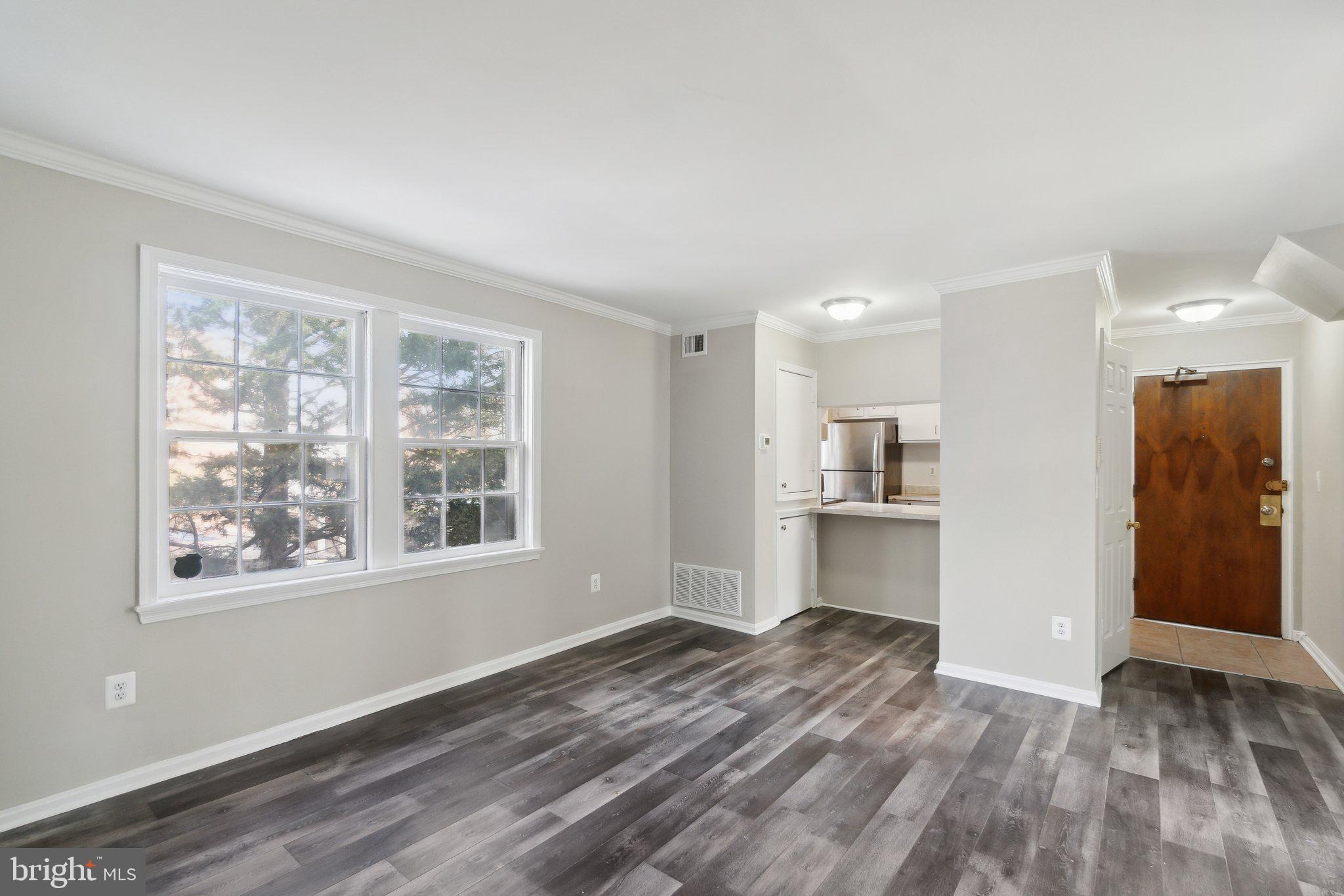 2016 37th Street Southeast, Unit 201 Washington, DC 20020 - Photo 7 of 17 a view of empty room with wooden floor and window