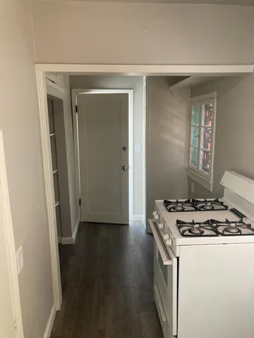 a kitchen with a stove and a refrigerator