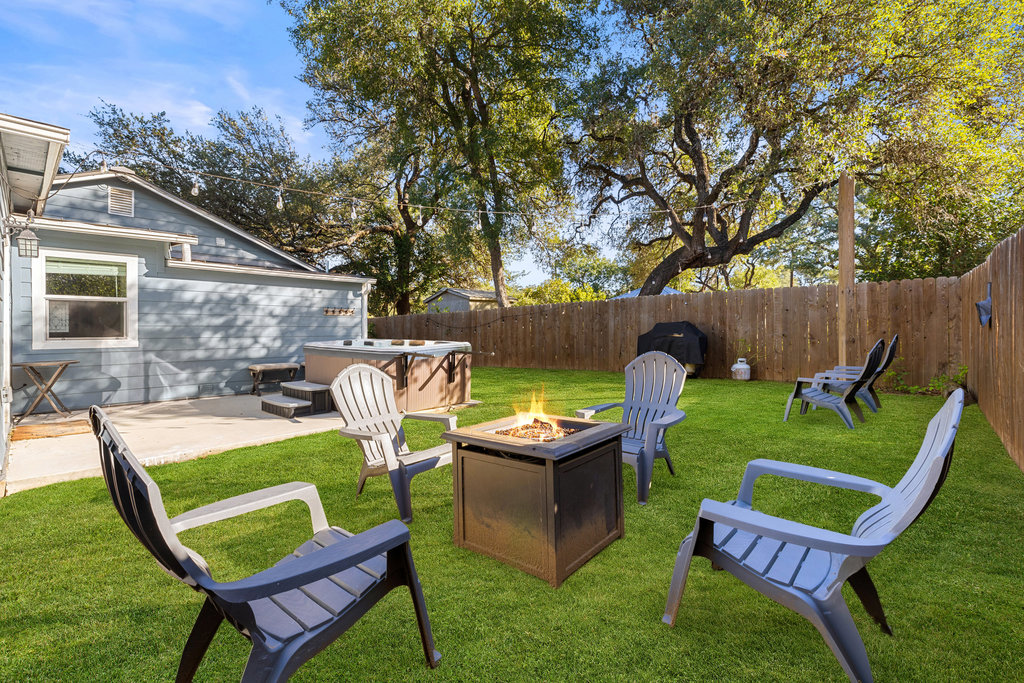 102 Ranchview Drive Johnson City, TX 78636 - Photo 35 of 37 Fenced backyard with a patio area, an outdoor fire pit, and a hot tub