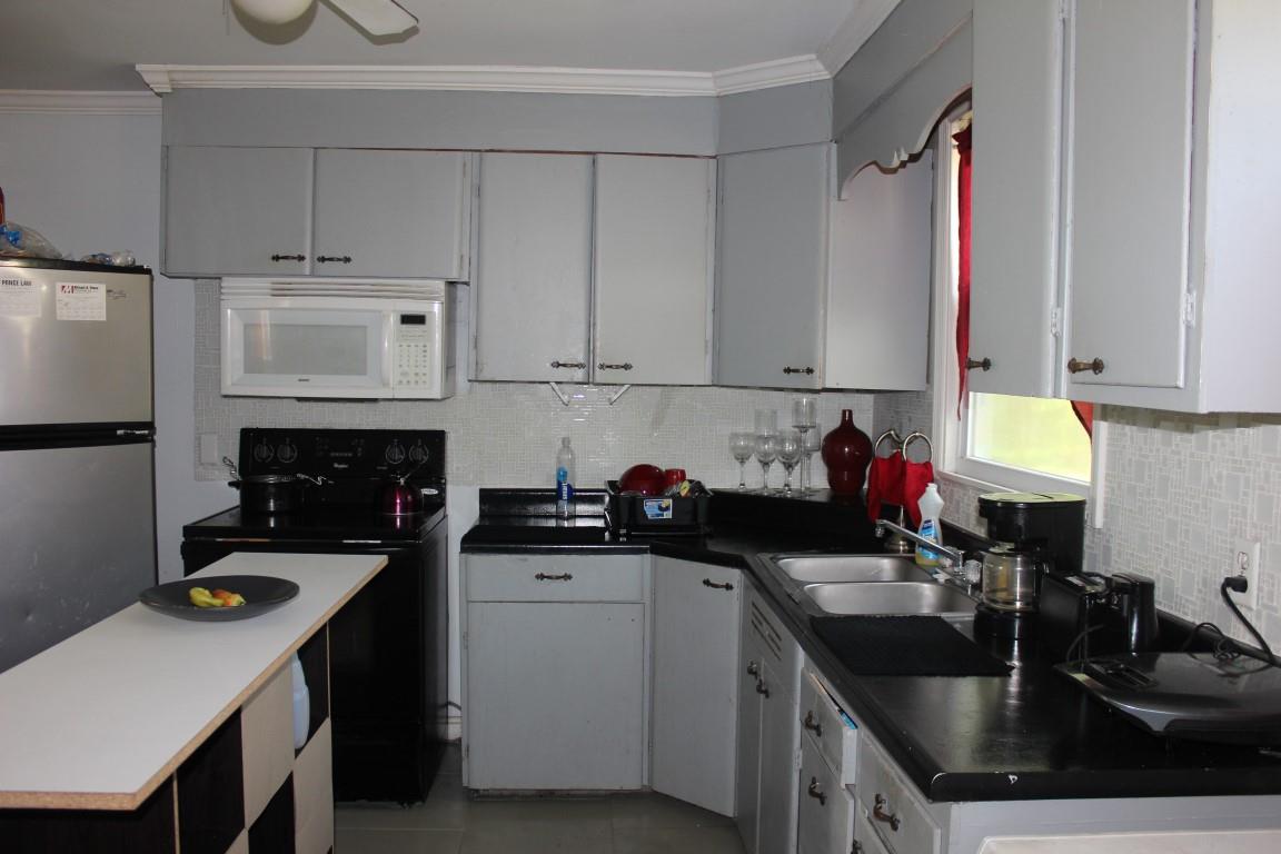 221 Randy Road Madison, TN 37115 - Photo 9 of 23 a kitchen with a sink a stove and cabinets