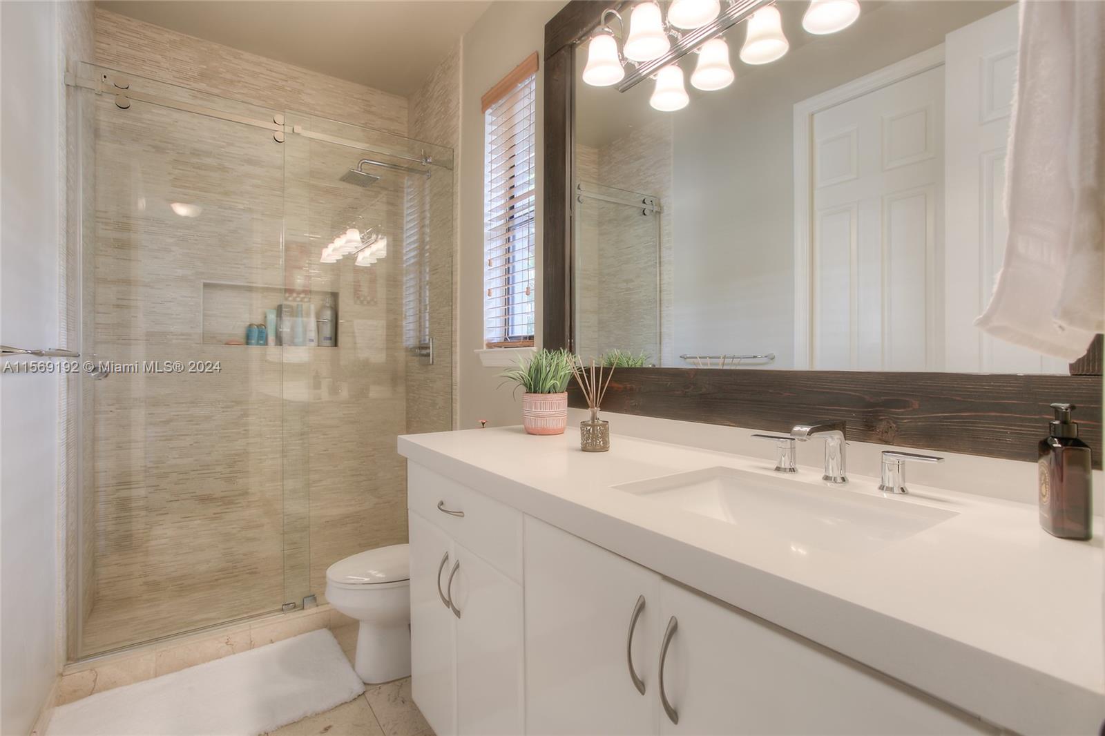 3053 Indiana Street, Unit 12 Miami, FL 33133 - Photo 12 of 23 a bathroom with a sink a toilet and shower