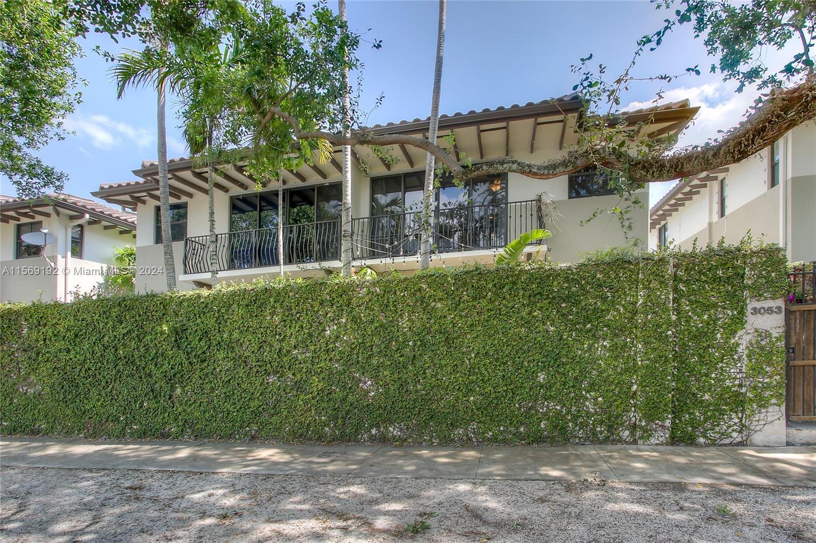 3053 Indiana Street, Unit 12 Miami, FL 33133 - Photo 2 of 23 a front view of a house with a garden