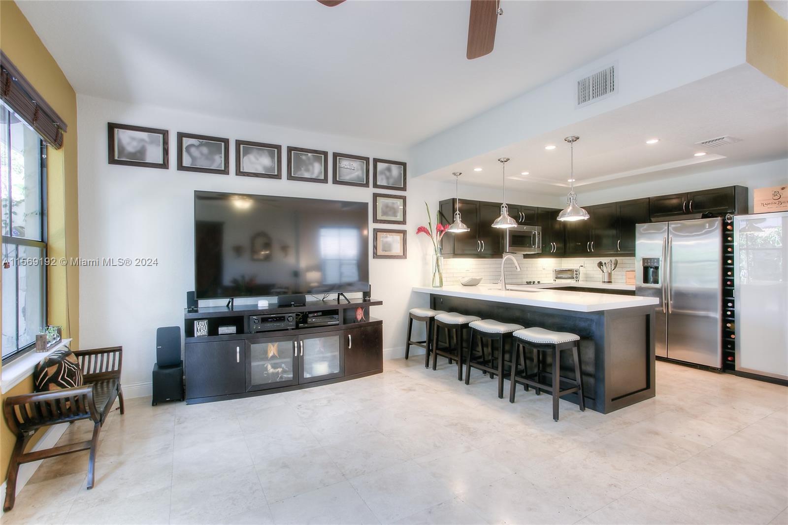 3053 Indiana Street, Unit 12 Miami, FL 33133 - Photo 7 of 23 a kitchen with stainless steel appliances kitchen island granite countertop a refrigerator and a stove top oven