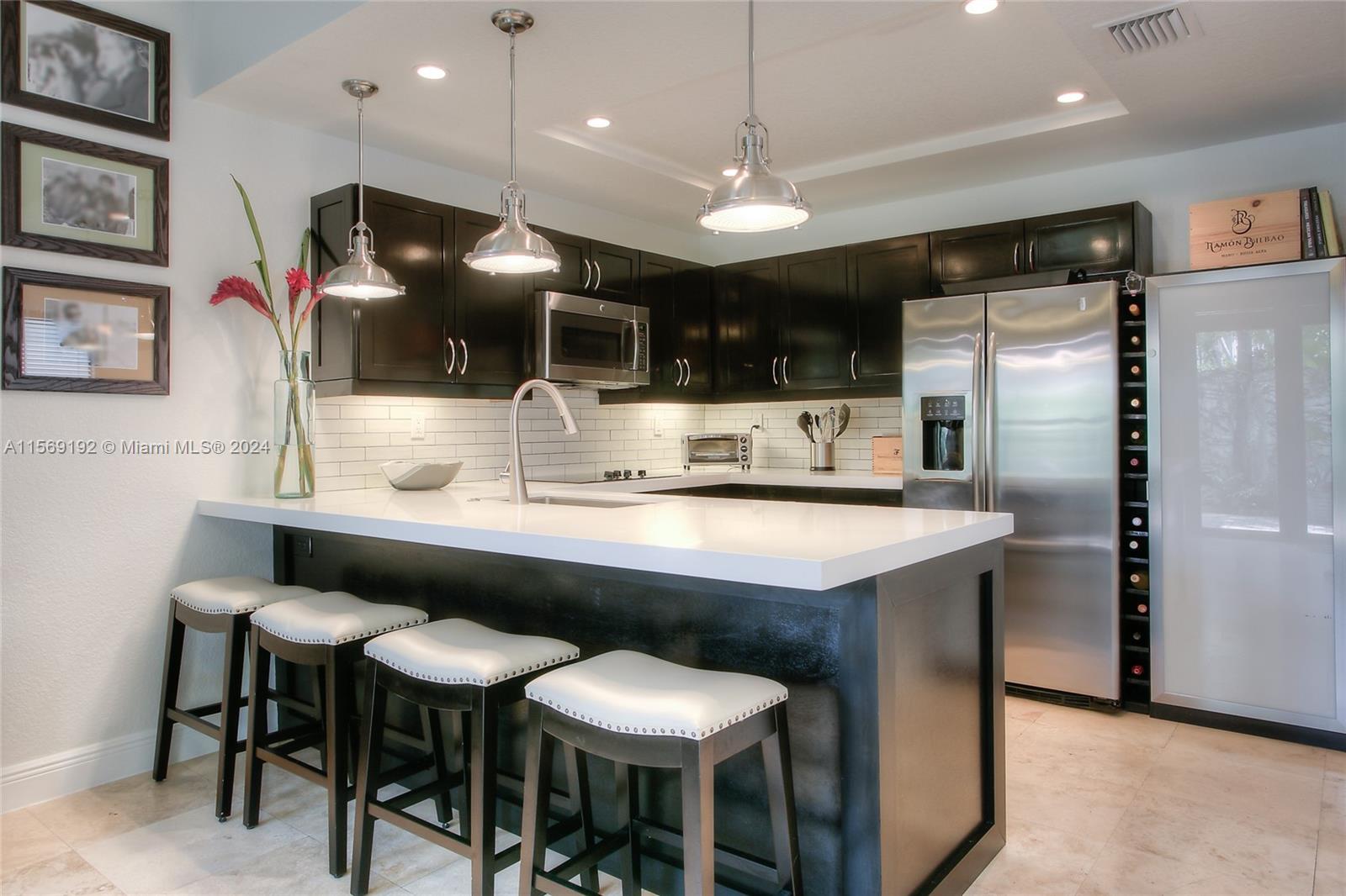 3053 Indiana Street, Unit 12 Miami, FL 33133 - Photo 10 of 23 a kitchen with a table and chairs in it