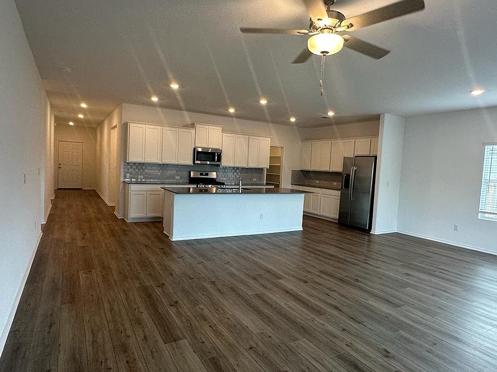 160 River Rise Road Kyle, TX 78640 - Photo 30 of 35 Open-concept living area featuring wood-finish flooring, recessed lighting, and a ceiling fan