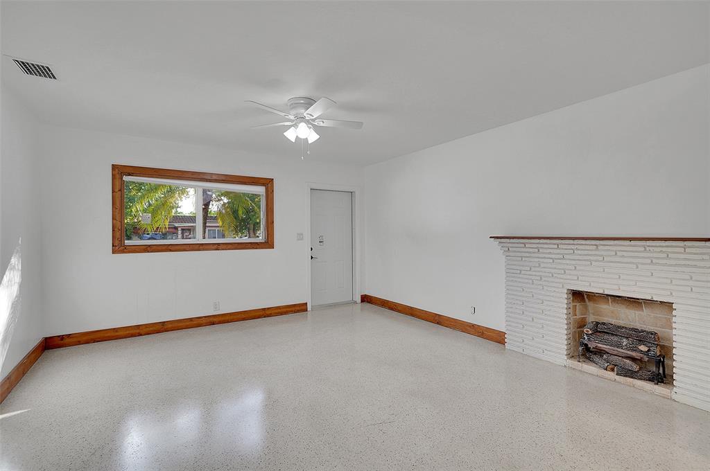 29 Southeast 8th Street Dania Beach, FL 33004 - Photo 11 of 42 an empty room with windows and fireplace