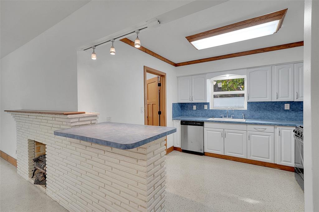 29 Southeast 8th Street Dania Beach, FL 33004 - Photo 14 of 42 a kitchen with granite countertop cabinets and sink