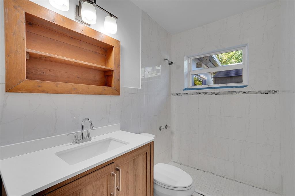 29 Southeast 8th Street Dania Beach, FL 33004 - Photo 23 of 42 a bathroom with a sink a toilet and mirror