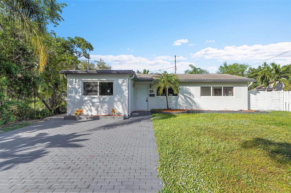 29 Southeast 8th Street Dania Beach, FL 33004 - Photo 3 of 42 a front view of a house with a yard and garage