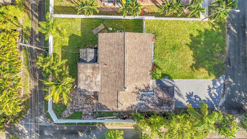 29 Southeast 8th Street Dania Beach, FL 33004 - Photo 7 of 42 an aerial view of a house with a yard and large trees