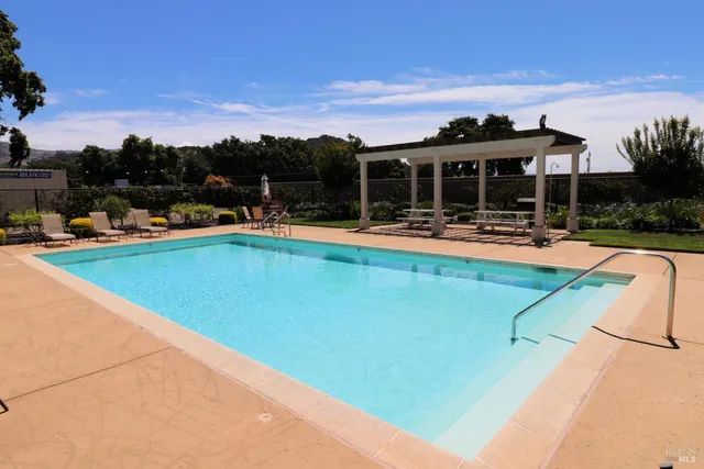a swimming pool with trees in the background