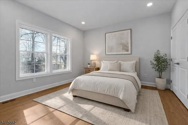 a bedroom with a large bed and a window