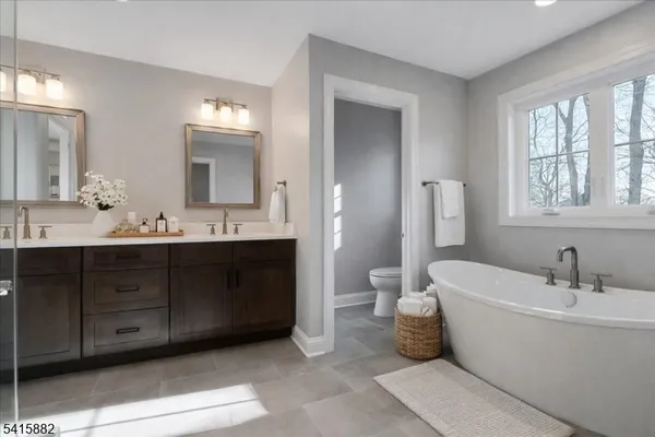 a bathroom with a double vanity sink and a mirror