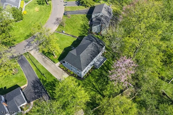 an aerial view of a house with a yard