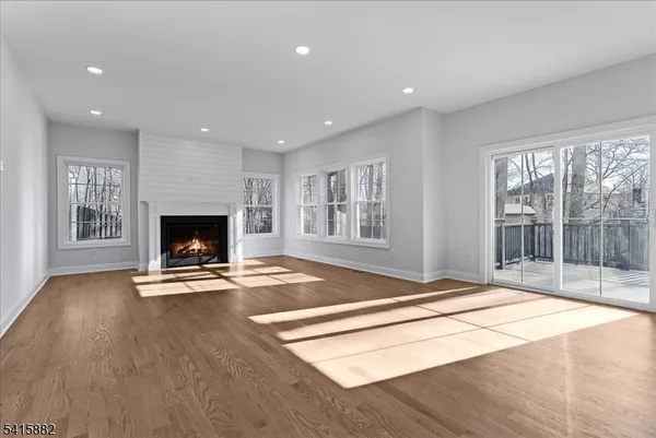 a view of livingroom with wooden floor and fireplace