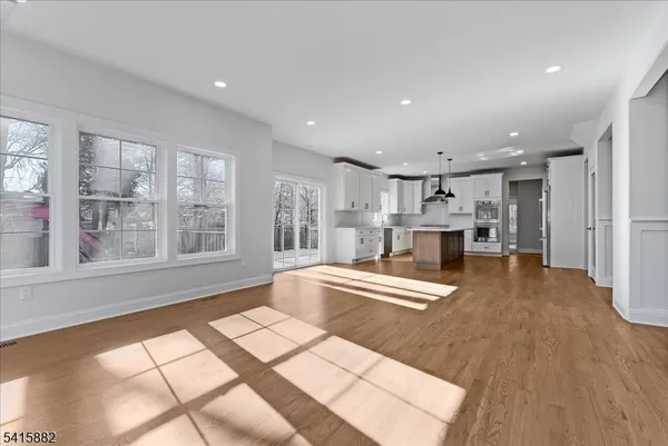 a living room with stainless steel appliances furniture and a fireplace