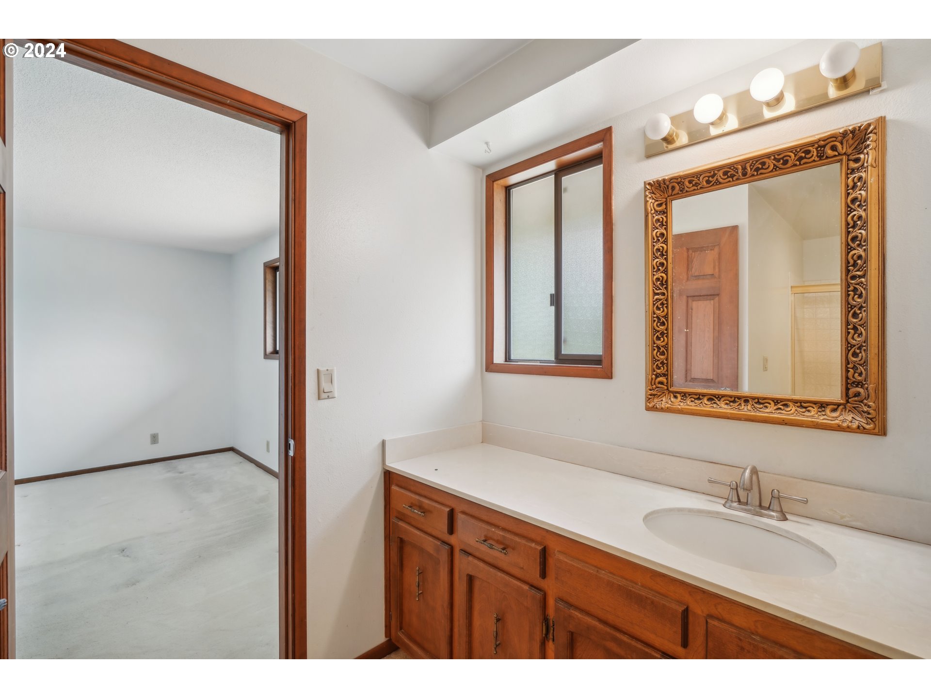 12795 Southeast Callahan Road Happy Valley, OR 97086 - Photo 22 of 42 a bathroom with a granite countertop sink mirror and a
