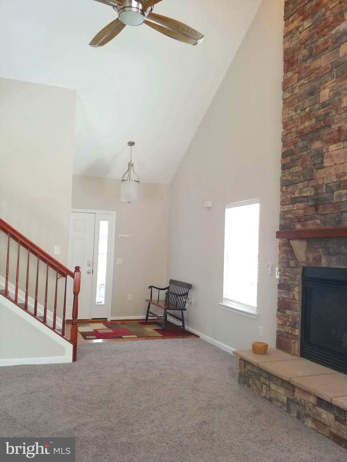 Foyer leads into spacious living room + staircase
