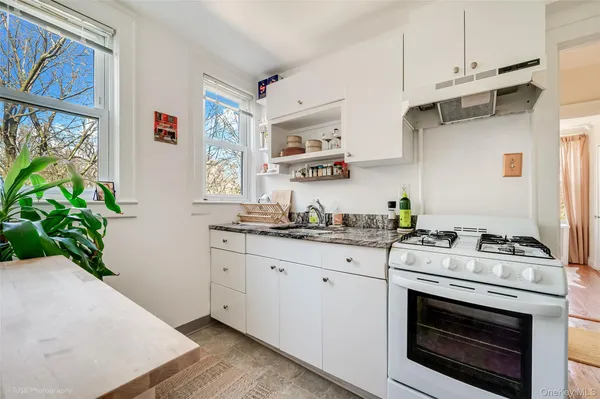 a kitchen with stainless steel appliances white cabinets and a stove