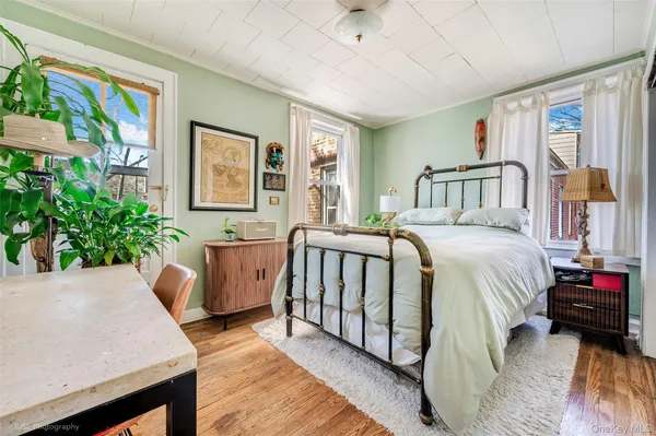a bed room with a bed and a potted plant