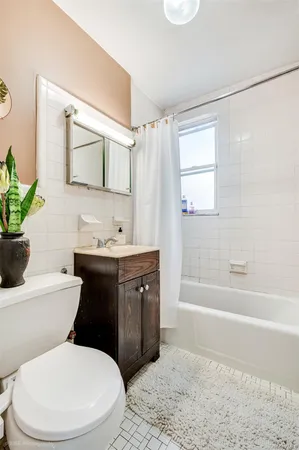 a bathroom with a granite countertop toilet sink and mirror