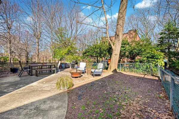 a view of backyard with swimming pool and seating space