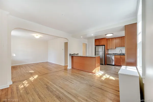 a view of kitchen with kitchen island refrigerator sink and wooden floor