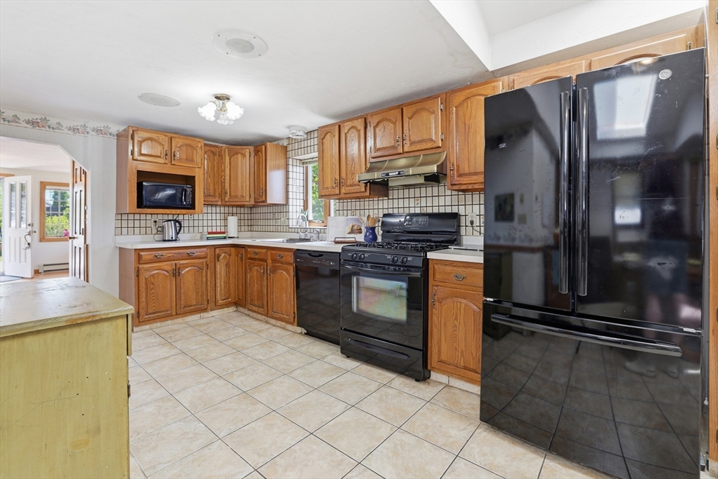 7 Swift Avenue Wareham, MA 02571 - Photo 6 of 42 a kitchen with stainless steel appliances granite countertop a refrigerator a stove top oven a sink and dishwasher