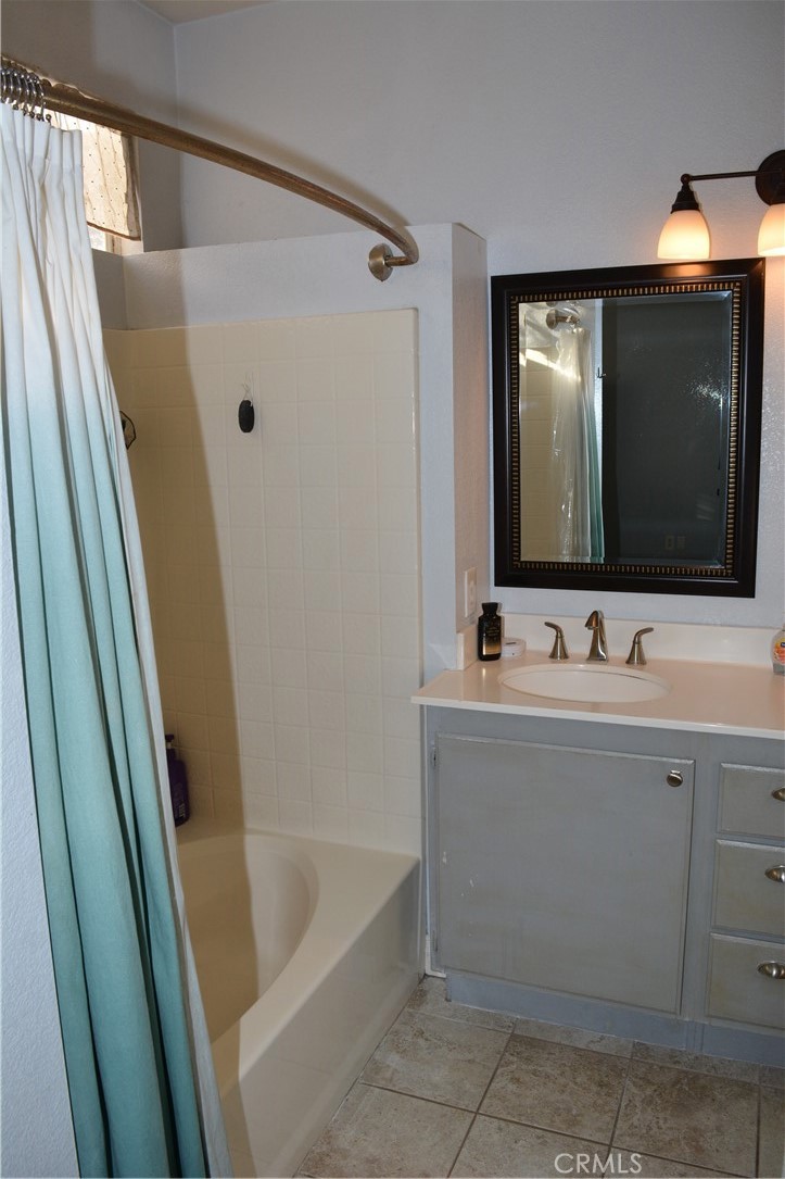 119 Draft Way Placentia, CA 92870 - Photo 16 of 24 a bathroom with a bathtub a mirror a sink and vanity