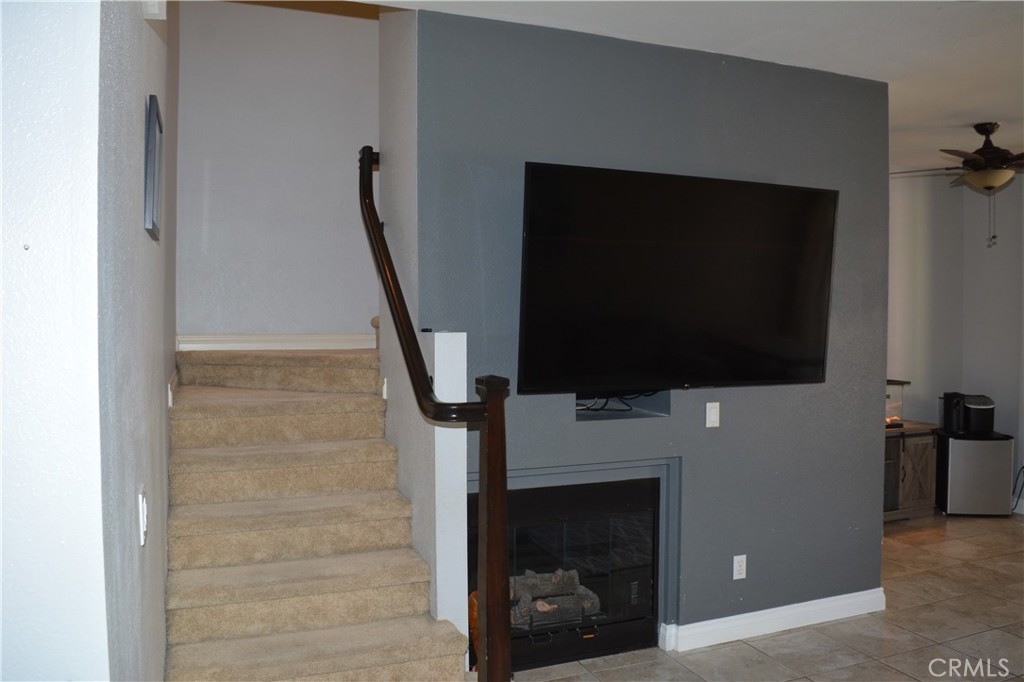 119 Draft Way Placentia, CA 92870 - Photo 7 of 24 a living room with a fireplace and a flat screen tv