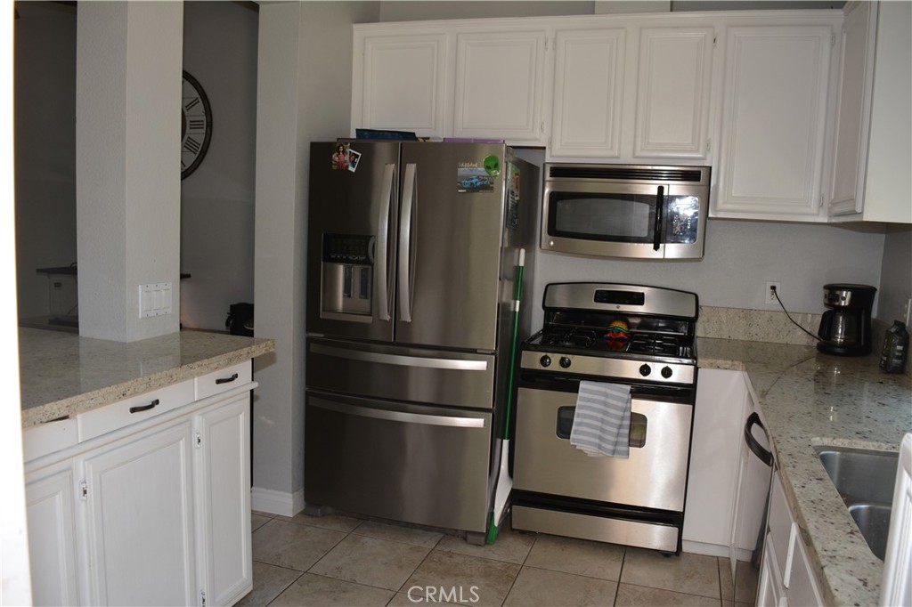 119 Draft Way Placentia, CA 92870 - Photo 8 of 24 a kitchen with stainless steel appliances granite countertop a refrigerator stove and microwave
