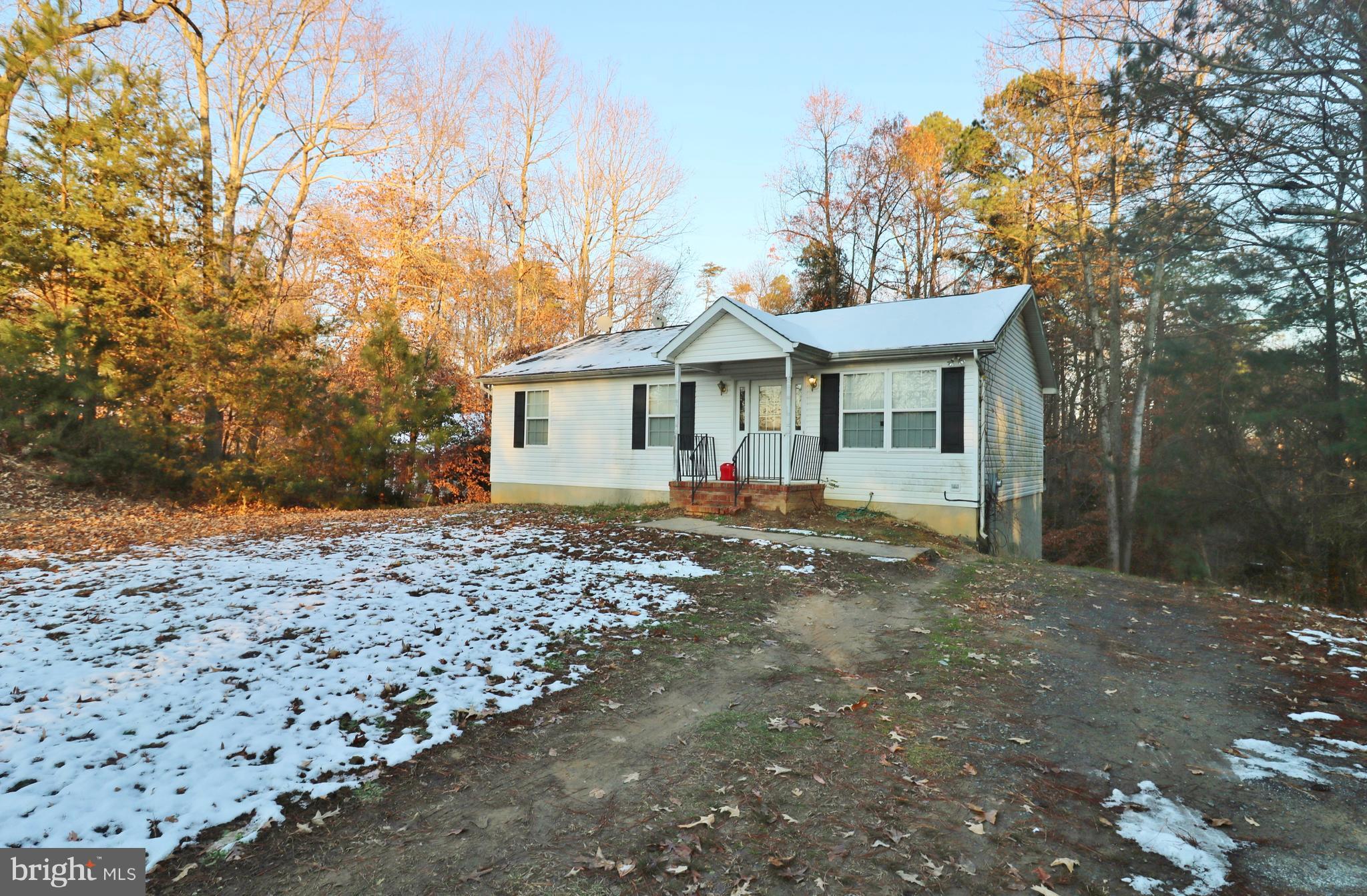 5924 Hillside Road St. Leonard, MD 20685 - Photo 1 of 24 a front view of a house with a yard