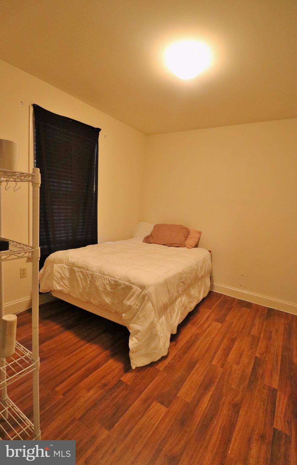5924 Hillside Road St. Leonard, MD 20685 - Photo 14 of 24 a bedroom with a bed and wooden floor