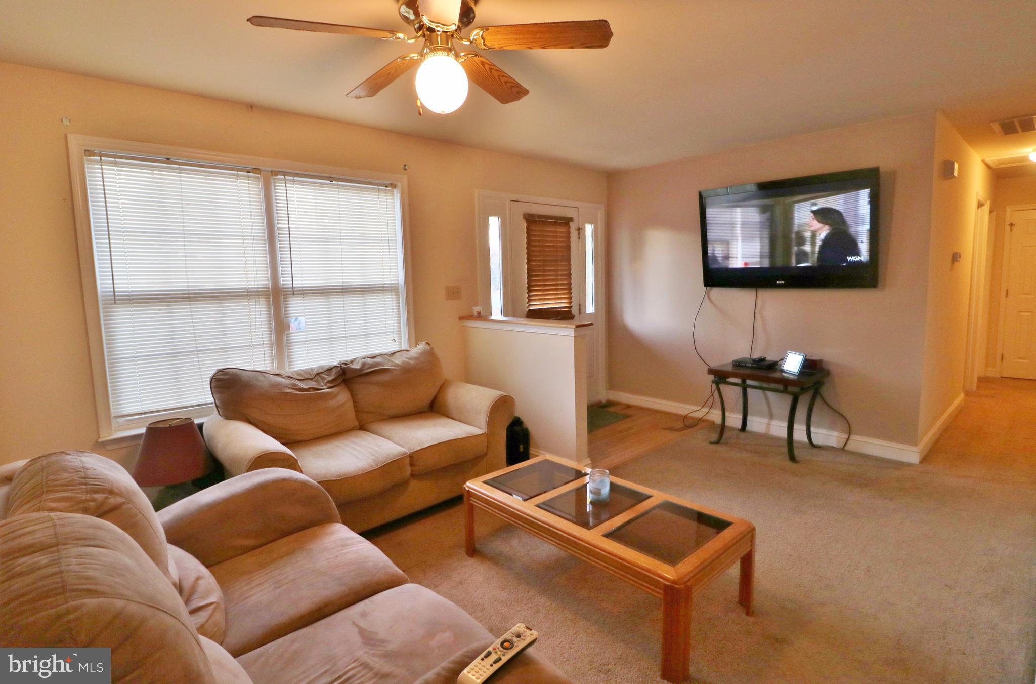 5924 Hillside Road St. Leonard, MD 20685 - Photo 3 of 24 a living room with furniture and a flat screen tv