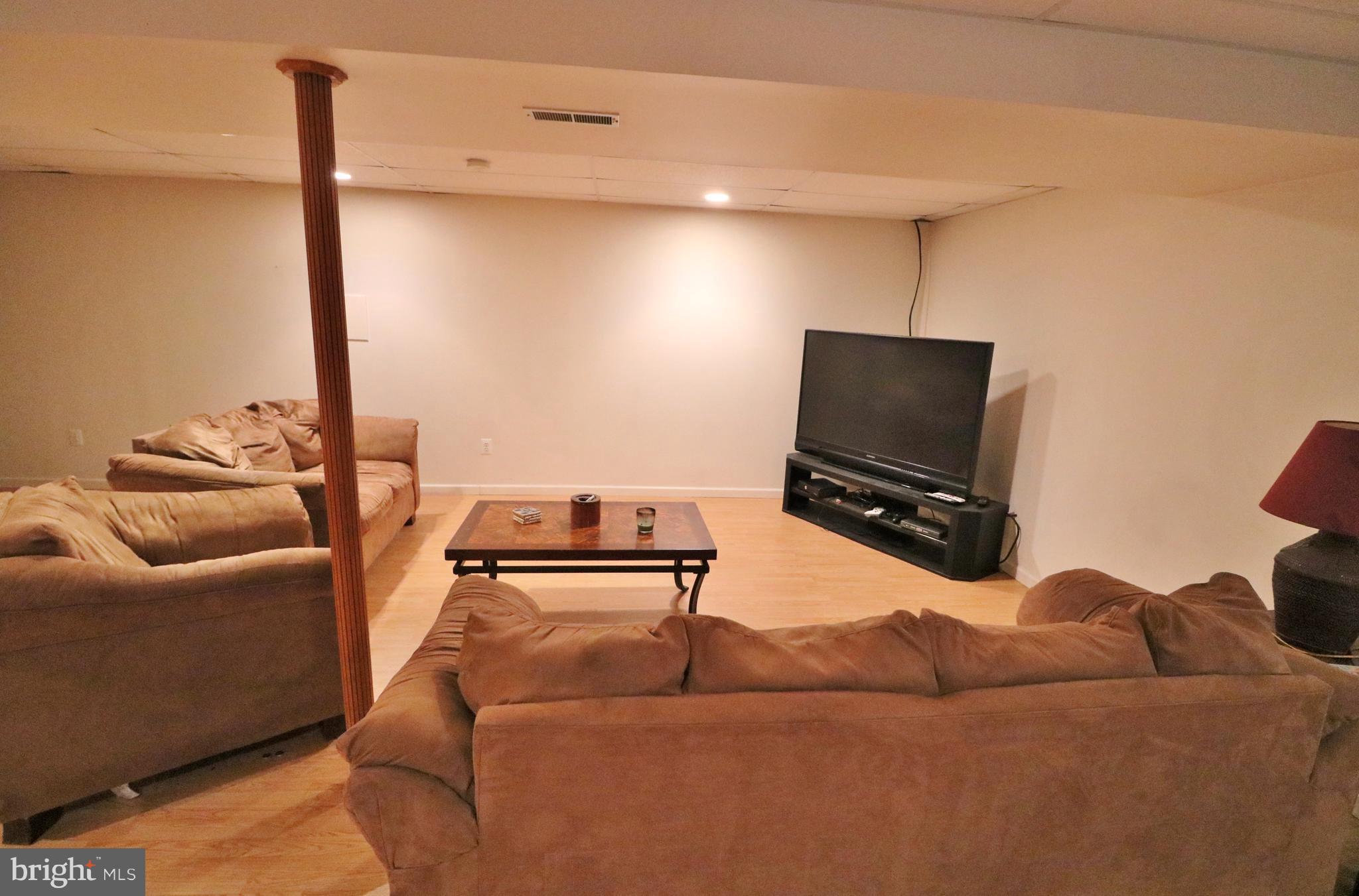 5924 Hillside Road St. Leonard, MD 20685 - Photo 4 of 24 a living room with furniture and a flat screen tv